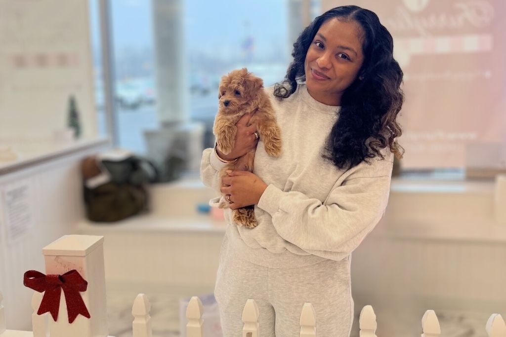 woman holding doodle mix puppy